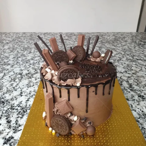 Chocolate cake with chocolates and Oreo toppings