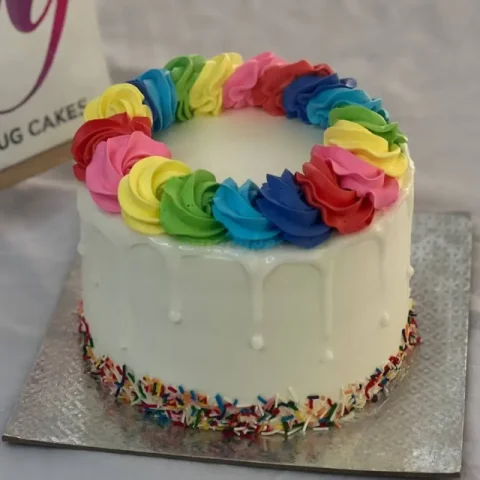 White Cake with Rainbow Frosting and Sprinkles